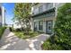 Exterior view of house featuring small yard, small tree, aqua doors and trim at 946 Highland Ave # 47, Dunedin, FL 34698