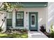 Charming home featuring a teal door, decorative plants and address number at 946 Highland Ave # 47, Dunedin, FL 34698