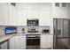 Modern kitchen featuring stainless steel appliances, granite countertops, and white cabinets at 946 Highland Ave # 47, Dunedin, FL 34698