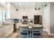 Well-lit kitchen offering white cabinets, stainless steel appliances, and a center island with marble countertops at 946 Highland Ave # 47, Dunedin, FL 34698