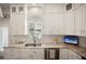 Bright kitchen features modern cabinets, granite countertops, stainless steel appliances, and a window with plantation shutters at 946 Highland Ave # 47, Dunedin, FL 34698