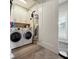 Well-equipped laundry area with washer, dryer, cabinets, and folding space for efficient chores at 946 Highland Ave # 47, Dunedin, FL 34698