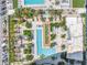 Aerial view of the pool, lounge areas, and landscaping with many palm trees at 100 1St N Ave # 3104, St Petersburg, FL 33701