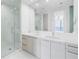 Modern bathroom with double sinks, large mirror, and glass-enclosed shower at 100 1St N Ave # 3104, St Petersburg, FL 33701