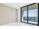 Bedroom with textured wallpaper and a sliding glass door leading to a balcony with an ocean view at 100 1St N Ave # 3104, St Petersburg, FL 33701