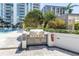 Outdoor grill and poolside recreation area with lounge chairs and lush landscaping at 100 1St N Ave # 3104, St Petersburg, FL 33701