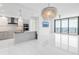 Bright, open-concept living room with modern kitchen, chandelier, and floor-to-ceiling windows with ocean views at 100 1St N Ave # 3104, St Petersburg, FL 33701