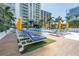 Stunning pool area with blue lounge chairs and yellow umbrellas offers a relaxing outdoor oasis at 100 1St N Ave # 3104, St Petersburg, FL 33701