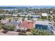 Aerial view showcases the property's terracotta roof, palm trees, and proximity to neighboring homes and the waterfront at 1008 Mandalay Ave, Clearwater, FL 33767
