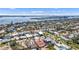 Expansive aerial view of a vibrant neighborhood with waterfront access and lush landscaping, showcasing the coastal lifestyle at 1008 Mandalay Ave, Clearwater, FL 33767