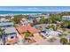 Aerial view of the home with a terracotta roof, surrounding residences, and beachfront access on a clear day at 1008 Mandalay Ave, Clearwater, FL 33767