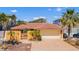Charming single-story home with a terra cotta roof, stucco exterior, and a well-manicured yard with tropical landscaping at 1008 Mandalay Ave, Clearwater, FL 33767