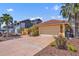 Charming single-story home with a terra cotta roof, stucco exterior, and a paved driveway with mature landscaping at 1008 Mandalay Ave, Clearwater, FL 33767
