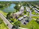 Aerial view of the community and condo buildings including parking near a beautiful lake at 108 Lakeview Ct # 108, Oldsmar, FL 34677