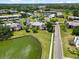 A picturesque aerial view captures the community's manicured grounds, pool and adjacent lake at 108 Lakeview Ct # 108, Oldsmar, FL 34677