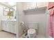 A clean and well-lit bathroom with white vanity and commode at 108 Lakeview Ct # 108, Oldsmar, FL 34677