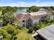 Exterior view of the condo showcasing tropical landscaping and a glimpse of the tranquil lake at 108 Lakeview Ct # 108, Oldsmar, FL 34677