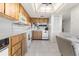 Spacious kitchen with white tile flooring, wooden cabinets, and white appliances at 108 Lakeview Ct # 108, Oldsmar, FL 34677