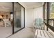 Comfortable lanai seating with view through sliding glass doors to living area at 108 Lakeview Ct # 108, Oldsmar, FL 34677