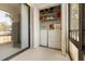 Convenient lanai closet with washer and dryer and shelving for storage at 108 Lakeview Ct # 108, Oldsmar, FL 34677