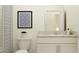 Cozy bathroom featuring a framed art piece, toilet, vanity and shower/tub with curtain at 10823 Fort White Ct, Tampa, FL 33647