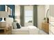 Inviting bedroom featuring a large window, soft gray drapes, and coordinating furnishings at 10823 Fort White Ct, Tampa, FL 33647
