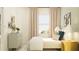 Bright bedroom featuring neutral tones, a serene window view, and stylish furnishings at 10823 Fort White Ct, Tampa, FL 33647
