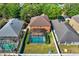 Aerial view of a backyard with a screened pool, surrounded by well-maintained houses and greenery at 11118 Running Pine Dr, Riverview, FL 33569