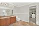Bathroom featuring double sinks, tiled floors, and walk-in closet at 11118 Running Pine Dr, Riverview, FL 33569