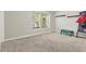 Spacious, carpeted bedroom with ample natural light from a window and space for a play area at 11118 Running Pine Dr, Riverview, FL 33569