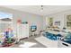 Bright, playful bedroom with a white dresser, shelving, and a cozy area rug at 11118 Running Pine Dr, Riverview, FL 33569