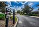 Gated community entrance featuring a security camera and well-maintained landscaping at 11118 Running Pine Dr, Riverview, FL 33569