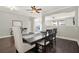 Dining room with dark hardwood floors, table with six chairs, and decorative bicycle console table at 11118 Running Pine Dr, Riverview, FL 33569