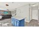 Bright kitchen featuring a center island with white countertop, blue cabinets and view to living area at 11118 Running Pine Dr, Riverview, FL 33569