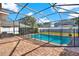 Screened-in pool area with brick pavers, black fencing, and backyard view at 11118 Running Pine Dr, Riverview, FL 33569