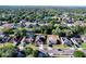 Aerial view of the home in a neighborhood with mature trees and a lake at 11535 Wellman Dr, Riverview, FL 33578