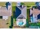 Aerial view of backyard pool and spa, patio, fenced yard and house roof at 11535 Wellman Dr, Riverview, FL 33578