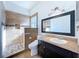 Bathroom featuring tiled walk-in shower, vanity with dark cabinets, and a commode at 11535 Wellman Dr, Riverview, FL 33578