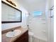 Bathroom with vanity with drawers, large mirror, and tiled shower-tub with shower head at 11535 Wellman Dr, Riverview, FL 33578