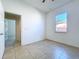 Bright bedroom featuring neutral tile flooring, a window and a large closet at 11535 Wellman Dr, Riverview, FL 33578