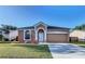 Beautiful single-story home with attached two-car garage and landscaped front yard at 11535 Wellman Dr, Riverview, FL 33578