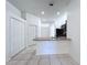 Kitchen features granite counters and an open design adjacent to white hallway at 11535 Wellman Dr, Riverview, FL 33578