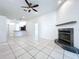 Spacious living room with tile flooring, fireplace, and view of the open kitchen at 11535 Wellman Dr, Riverview, FL 33578
