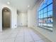 Bright living room with large windows, neutral walls, and tile flooring at 11535 Wellman Dr, Riverview, FL 33578