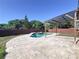 Backyard pool and spa features a covered patio area and fenced yard at 11535 Wellman Dr, Riverview, FL 33578