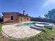 Backyard pool and spa is surrounded by a stone paver patio and mature landscaping at 11535 Wellman Dr, Riverview, FL 33578