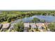 Beautiful aerial view showcasing the home's lakeside location with mature tree coverage and neighboring homes at 11639 Sunshine Pond Rd, Tampa, FL 33635