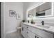 Modern bathroom with double sinks, marble countertops, and a sleek, illuminated mirror at 11639 Sunshine Pond Rd, Tampa, FL 33635