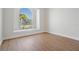 Bright, spacious bedroom featuring sleek, modern wood flooring at 11639 Sunshine Pond Rd, Tampa, FL 33635