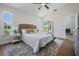 Bright bedroom offers plush rug, natural light, and scenic lake views from windows and sliding doors at 11639 Sunshine Pond Rd, Tampa, FL 33635